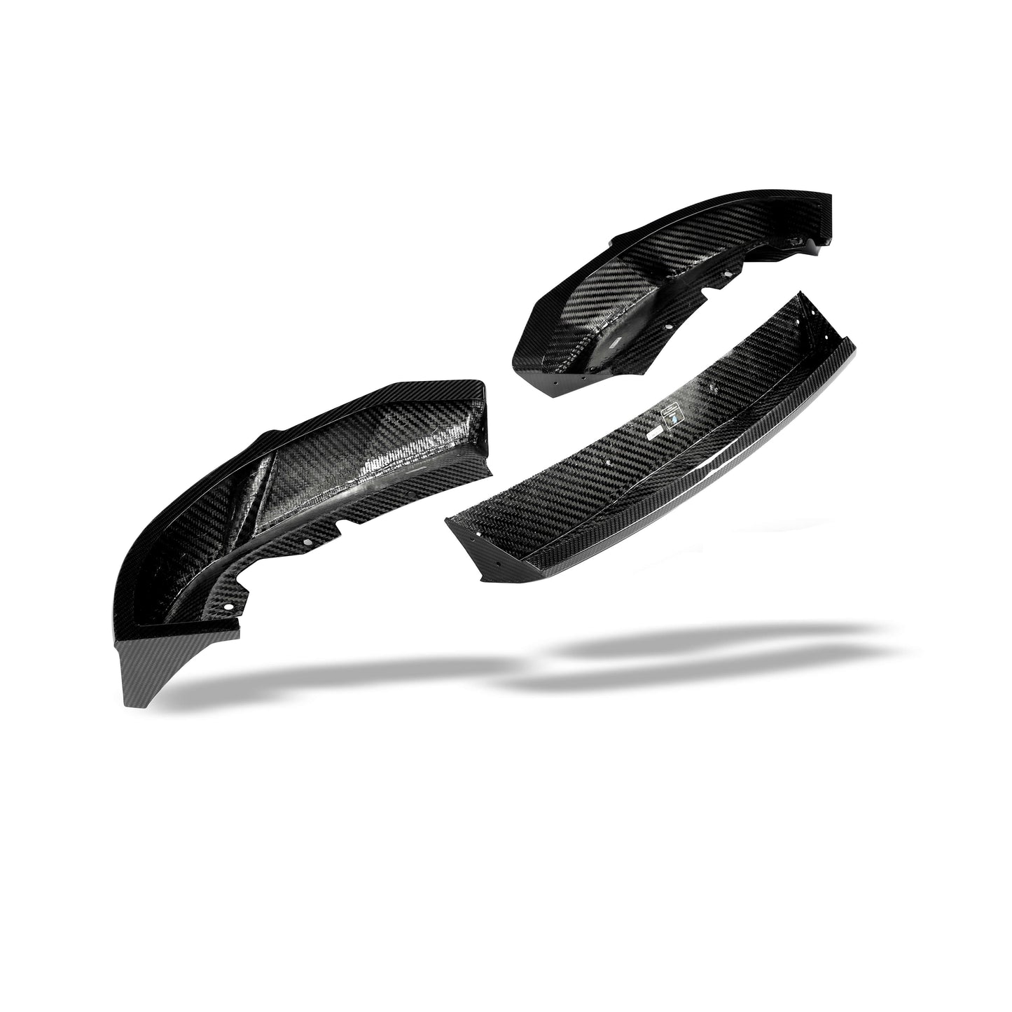 BMW XM G09 carbon fiber front lip angled view along the bumper line