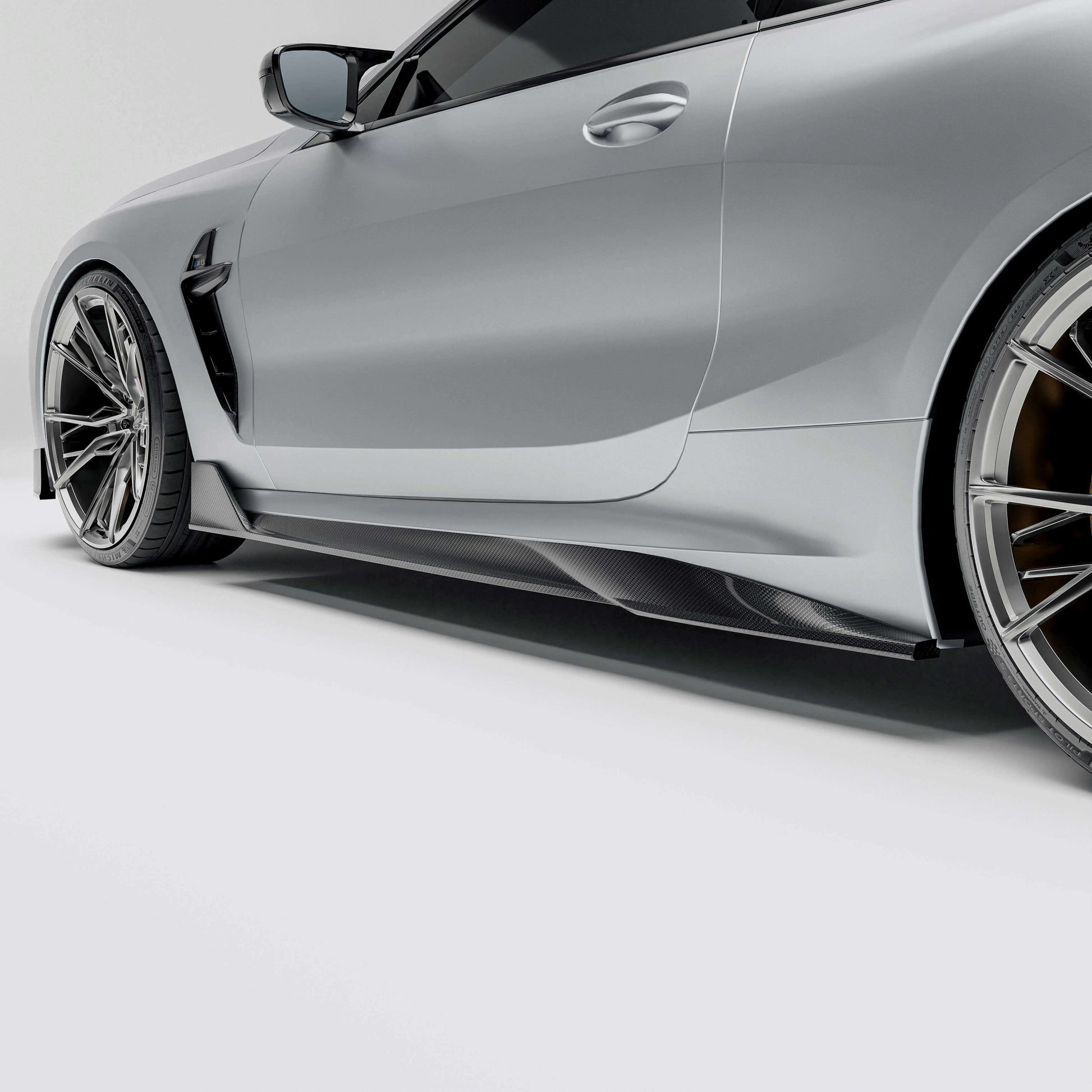 BMW M8 F91 F92 carbon fiber side skirt close-up on rocker panel