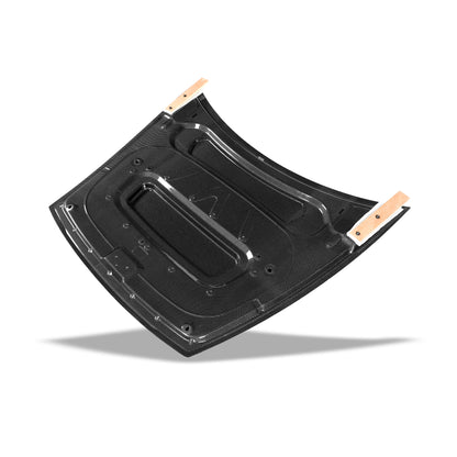 Carbon fiber hood seated on factory mounting points of Model Y facelift