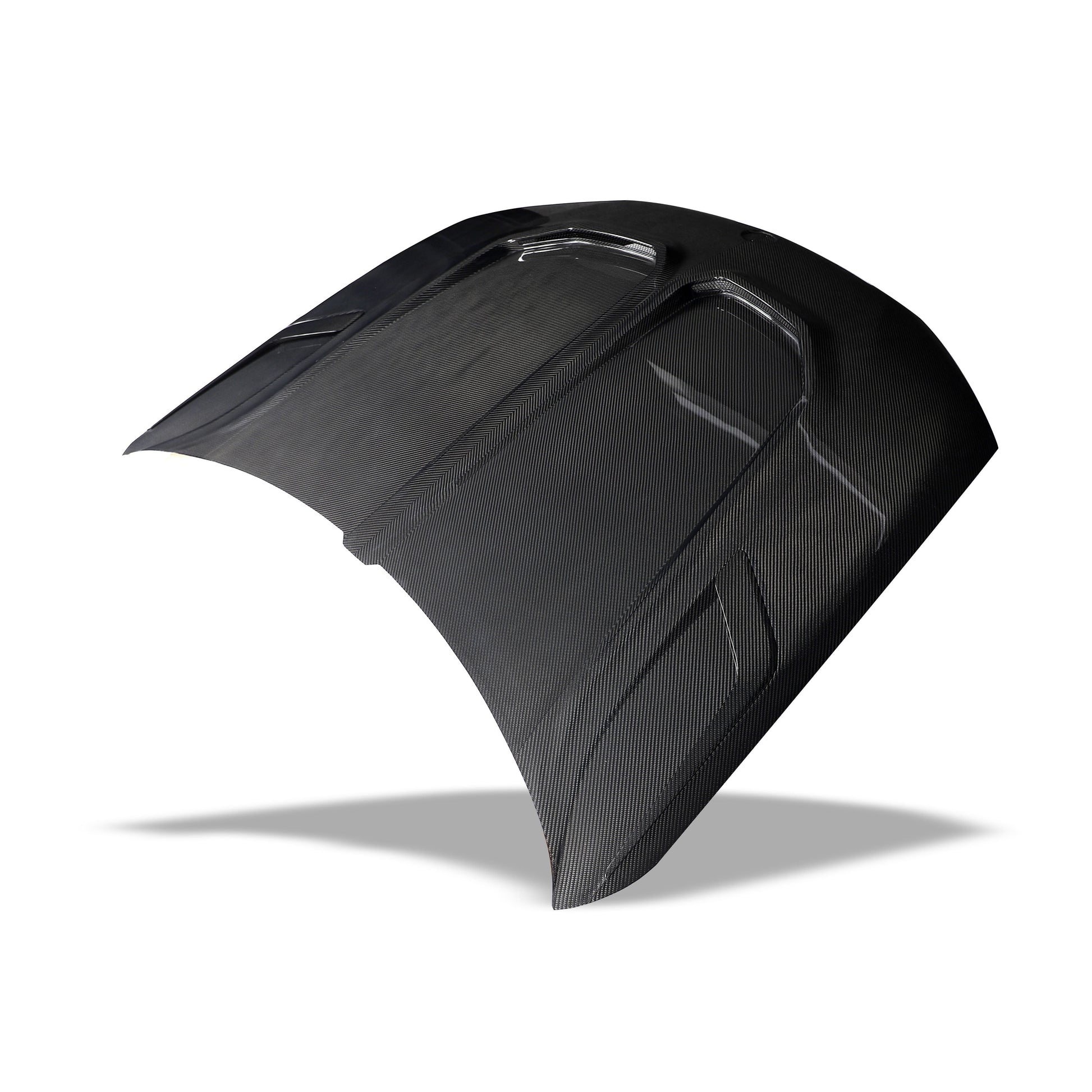 Angled view of the X6M F96 carbon fiber hood styling